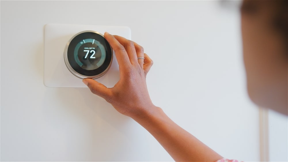 Close,Up,Of,Woman,Setting,Digital,Smart,Heating,Thermostat,At