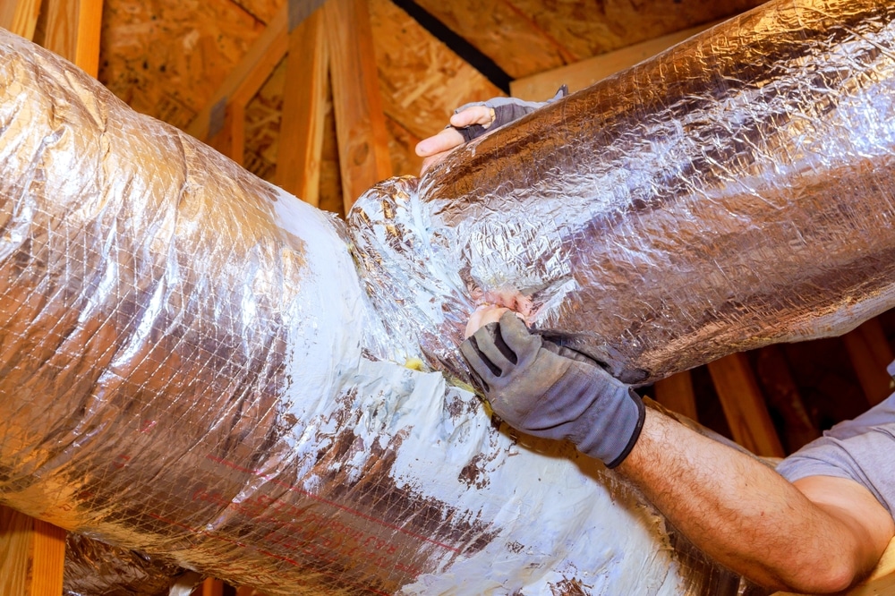 Workers,Are,Sealing,Duct,Connections,In,Attic,To,Ensure,Proper